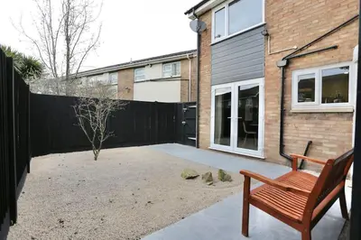 a wooden bench sitting in front of a house at xxBrand Newxx sleeps 8, stylish japandi house in Blackpool