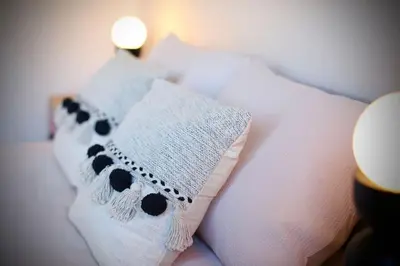 a pillow with a panda bear on it on a bed at xxBrand Newxx sleeps 8, stylish japandi house in Blackpool
