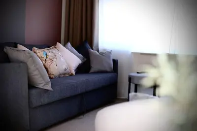 a living room with a blue couch with pillows at xxBrand Newxx sleeps 8, stylish japandi house in Blackpool