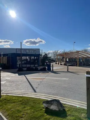 an empty parking lot next to a building at Caravan - Sleeps up to 8 & Free parking in Grange Over Sands