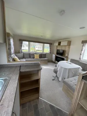 a living room with a couch and a table at Caravan - Sleeps up to 8 & Free parking in Grange Over Sands