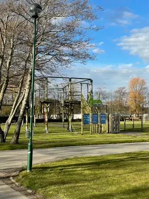 a street light next to a playground in a park at Caravan - Sleeps up to 8 & Free parking in Grange Over Sands
