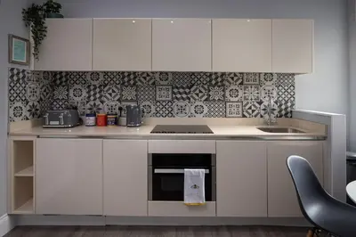 a kitchen with white cabinets and a stove top oven at Coral Boutique Apartment 1 in Blackpool