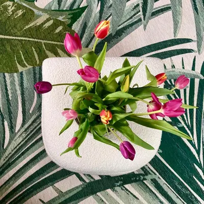 a white vase filled with pink flowers on a table at The Comfy Flat- Modern & Bright 2 Bedrooms Apartment in Liverpool