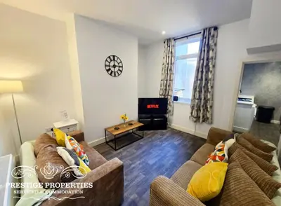 a living room with two couches and a tv at Manchester St by Prestige Properties SA in Barrow in Furness
