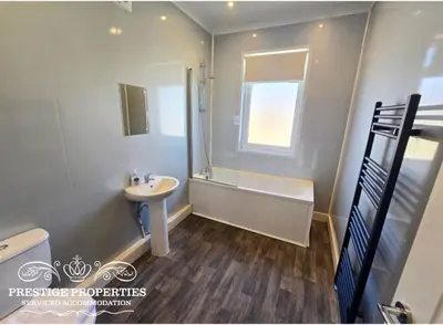 a bathroom with a sink and a toilet and a tub at Manchester St by Prestige Properties SA in Barrow in Furness