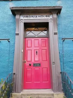 a red door in a building with a blue wall at Virginia House, Ulverston in Ulverston