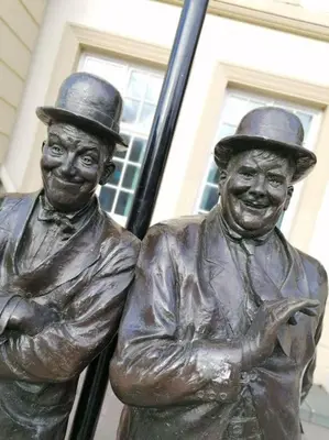 a statue of two men standing next to each other at Virginia House, Ulverston in Ulverston