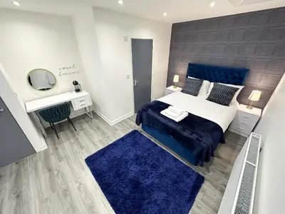 a bedroom with a bed and a desk and a mirror at Regent Docks-Free Parking in Liverpool