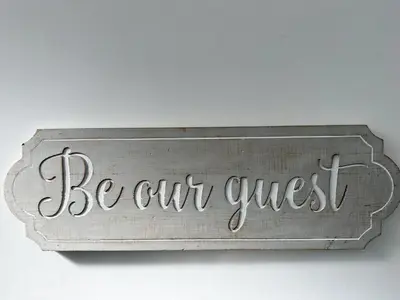 a sign that says be our guest on a wall at Regent Docks-Free Parking in Liverpool