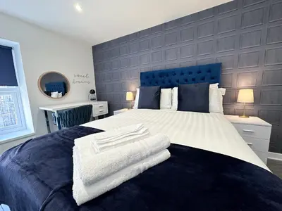 a bedroom with a large bed with towels on it at Regent Docks-Free Parking in Liverpool
