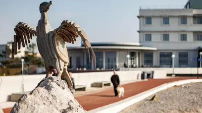 a statue of an eagle with a person and a dog at Altham Place-Free Parking Space in Morecambe