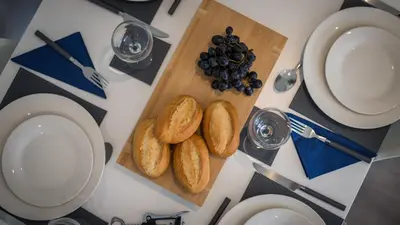 a table with a cutting board with bread and grapes at Altham Place-Free Parking Space in Morecambe