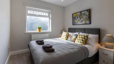 a bedroom with a bed with pillows and a window at Altham Place-Free Parking Space in Morecambe