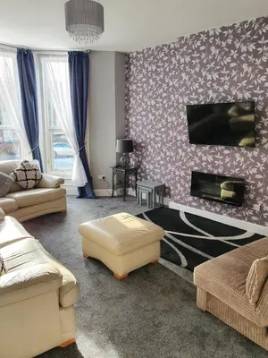 a living room with a couch and a fireplace at Imperial view in Blackpool