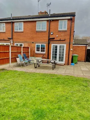 a patio with two chairs and a table in front of a house at 2 bed house sleeps 4-5 in Liverpool