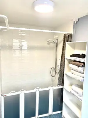 a bathroom with a shower and some towels at 2 bed house sleeps 4-5 in Liverpool