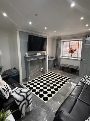 a living room with a checkered floor and a fireplace at 2 bed house sleeps 4-5 in Liverpool