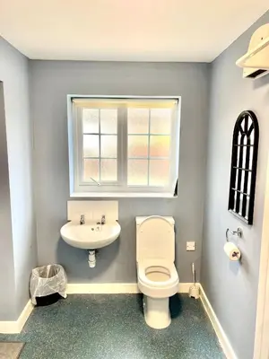 a bathroom with a toilet and a sink and a window at 2 bed house sleeps 4-5 in Liverpool