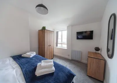 a bedroom with a bed with two towels on it at Beautiful 7 bed home, ideal for groups, sleeps 11! in Morecambe