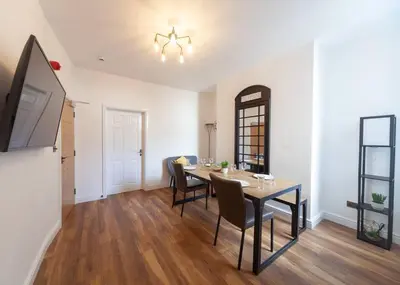 a dining room with a table and chairs at Beautiful 7 bed home, ideal for groups, sleeps 11! in Morecambe
