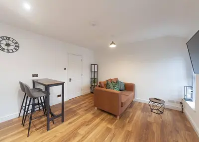 a living room with a couch and a table at Beautiful 7 bed home, ideal for groups, sleeps 11! in Morecambe