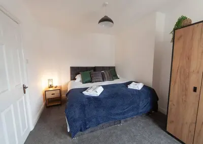 a bedroom with a bed with two towels on it at Beautiful 7 bed home, ideal for groups, sleeps 11! in Morecambe