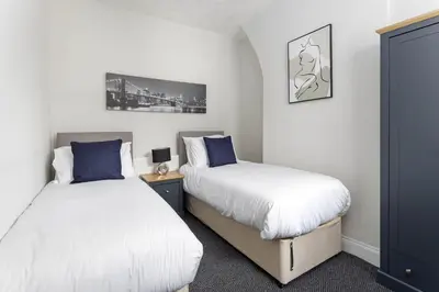 a bedroom with two beds and a night stand at Toft House - Air Host & Stay - Free Parking - Contractor Friendly in Liverpool