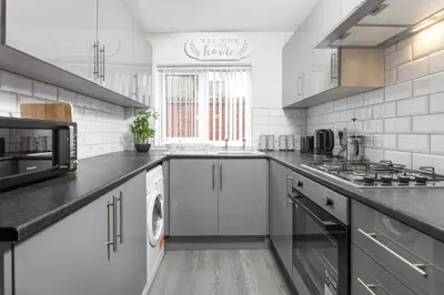 a white kitchen with a stove and a sink at Toft House - Air Host & Stay - Free Parking - Contractor Friendly in Liverpool