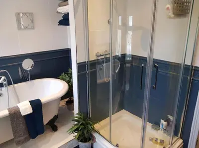 a bathroom with a tub and a glass shower at Lytham Luxury in Saint Annes on the Sea