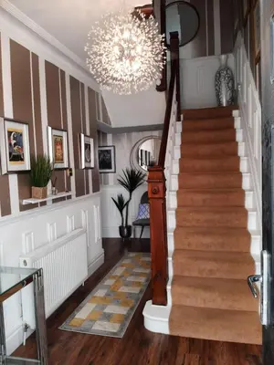a staircase in a home with a chandelier at Lytham Luxury in Saint Annes on the Sea