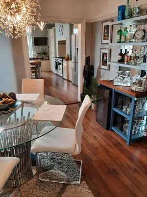 a living room with a glass table and chairs at Lytham Luxury in Saint Annes on the Sea