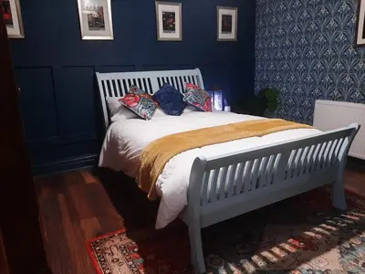 a bedroom with a white bed with blue walls at Lytham Luxury in Saint Annes on the Sea