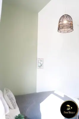 a bedroom with a bird cage hanging from a ceiling at Bee Stays - Cooper House in Haydock