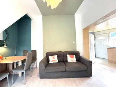 a living room with a couch and a table at Bee Stays - Cooper House in Haydock