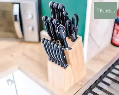 a knife block filled with knives on a counter at Perfect Contractor House in Liverpool with 7 Beds By PureStay - 14 nights min! in Liverpool