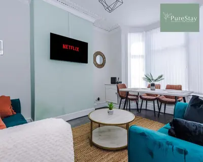 a living room with a couch and a table at Perfect Contractor House in Liverpool with 7 Beds By PureStay - 14 nights min! in Liverpool