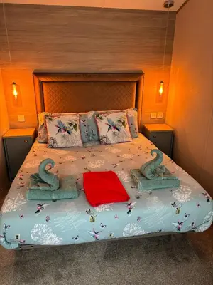 a bedroom with a bed with two numbers on it at Hummingbird Retreat in Blackpool
