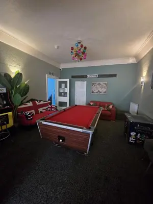 a living room with a pool table in it at Maydene Hotel in Blackpool