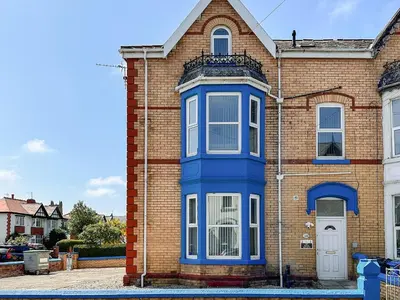 a blue door on the side of a brick house at Two - Uk43700 in Saint Annes on the Sea