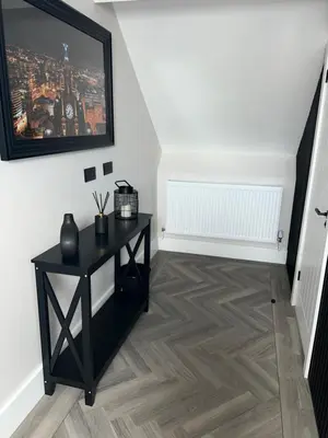 a room with a black table and a tv on a wall at 128 Anfield Road in Liverpool