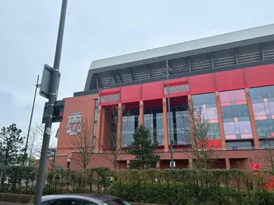 a large building with a red at 128 Anfield Road in Liverpool