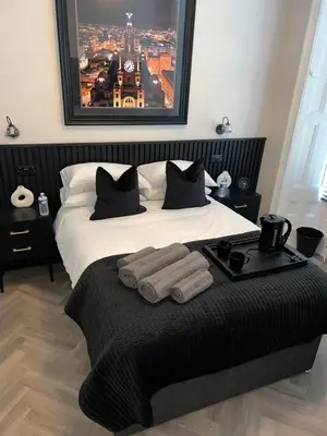 a bedroom with a bed with towels on it at 128 Anfield Road in Liverpool