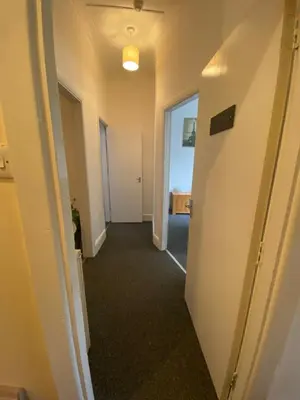 a hallway of an office with a door and a hallway at The Snug on Hornby in Morecambe