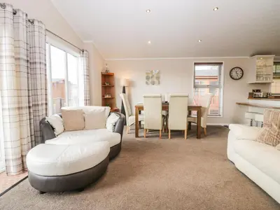 a living room with two couches and a table at Walkers Rest in Carnforth