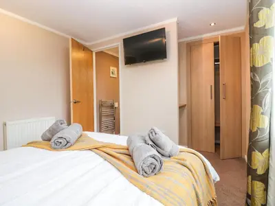 a bedroom with a bed with towels on it at Walkers Rest in Carnforth