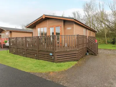 a small house with a wooden fence around it at Walkers Rest in Carnforth