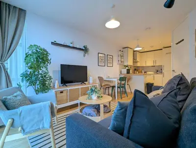 a living room with a couch and a tv at City Centre Morden 1-Bedroom Apt Near Dock in Liverpool