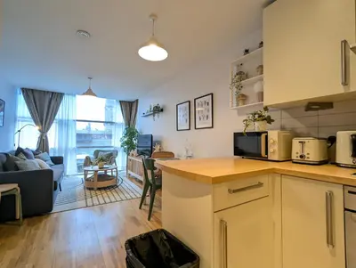 a kitchen and living room with a living room at City Centre Morden 1-Bedroom Apt Near Dock in Liverpool