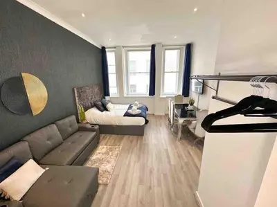 a living room with a couch and a bed at Align Lux Apartments, Liverpool City Centre in Liverpool